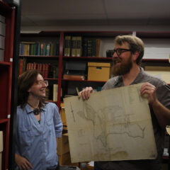 Dr. Jeff Keith works with a library archives student.